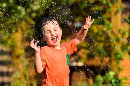 Kid in the sprinkler