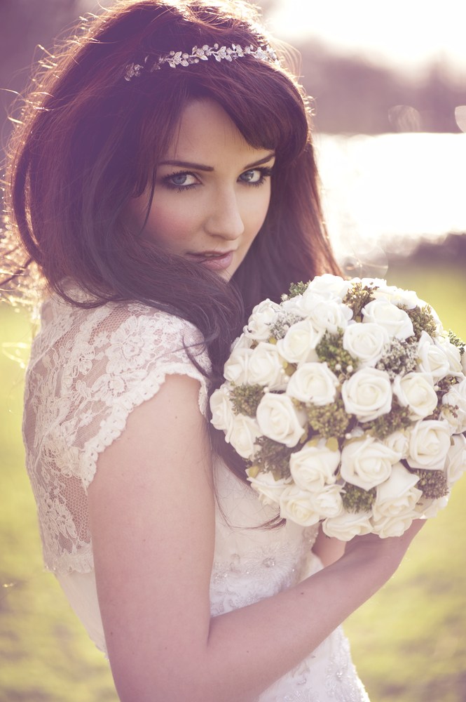 Bashful bride with white bouquet