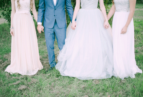 Bride and groom holding hands with bridesmaids