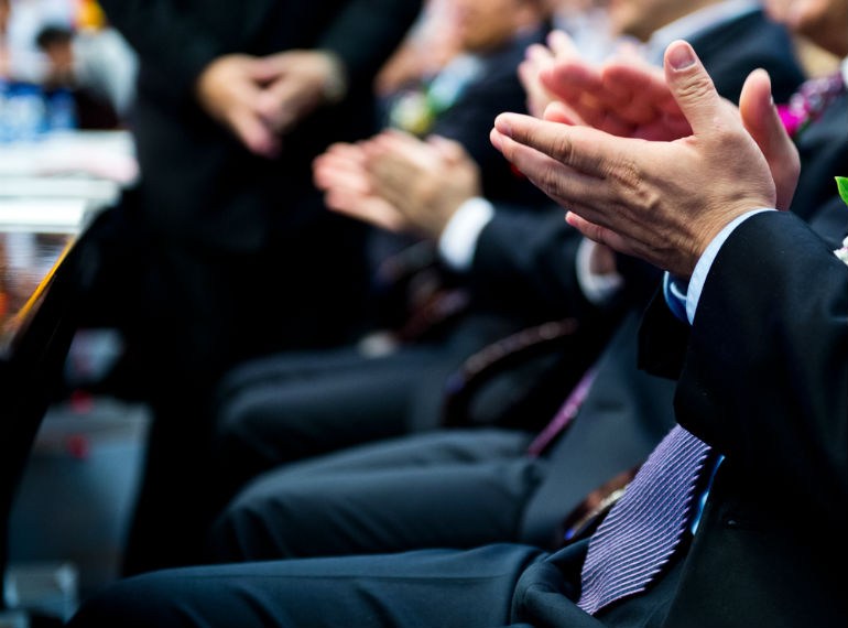 Clapping hands in suits