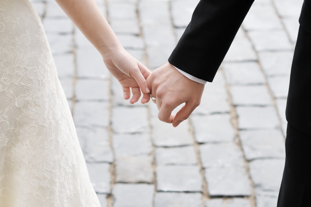 Bride and groom holding hands