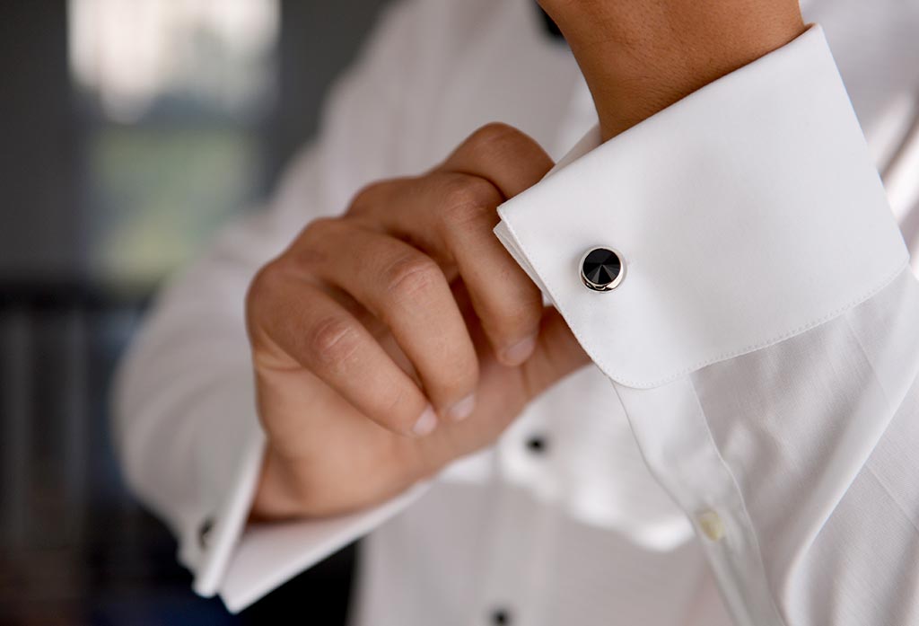 Groom getting dressed for wedding