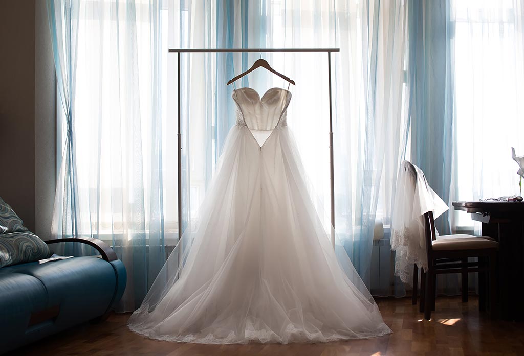 Wedding dress hanging infront of window