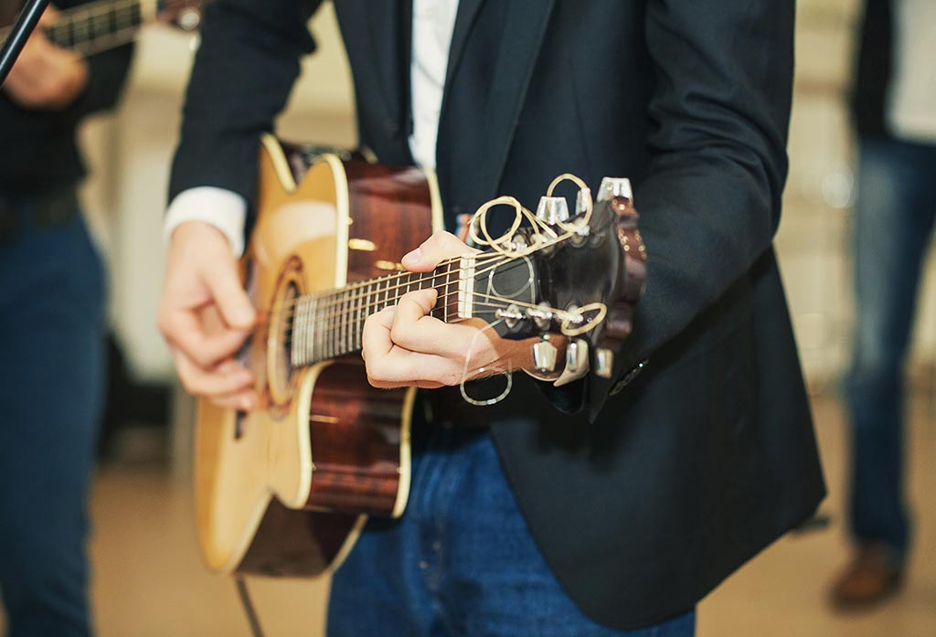 Musician playing acoustic guitar