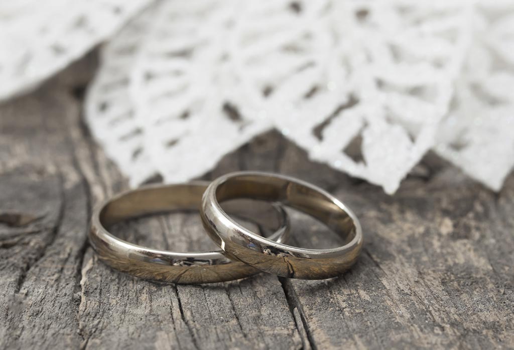 Plain silver wedding rings on timber table