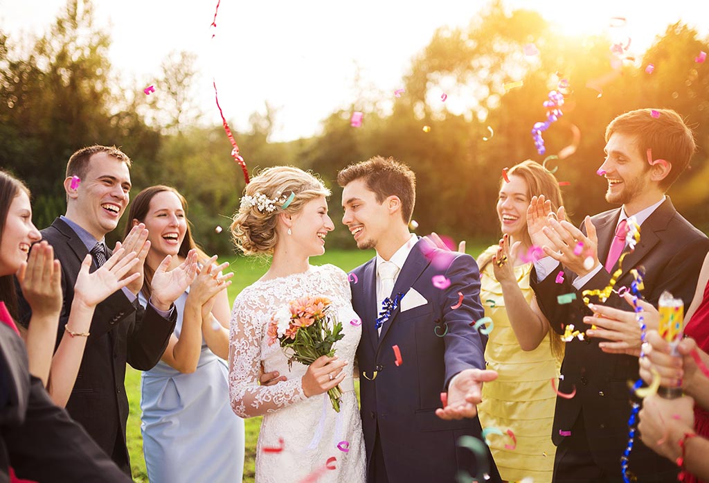 Just married couple surrounded by guests