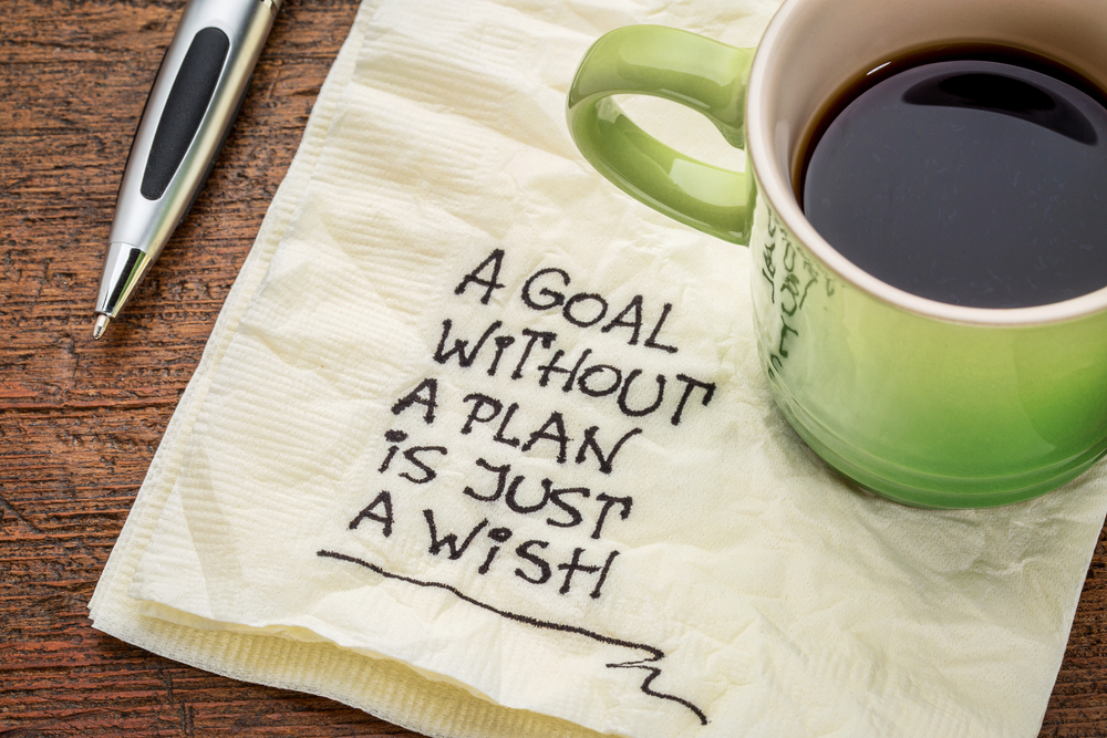 A napkin and coffee with the words "A goal without a plan is just a wish"