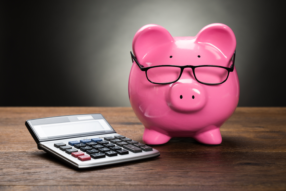 Piggy bank and Calculator for fundraising budget.