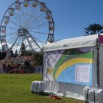 Festival marquees for hire and a ferris wheel in the background